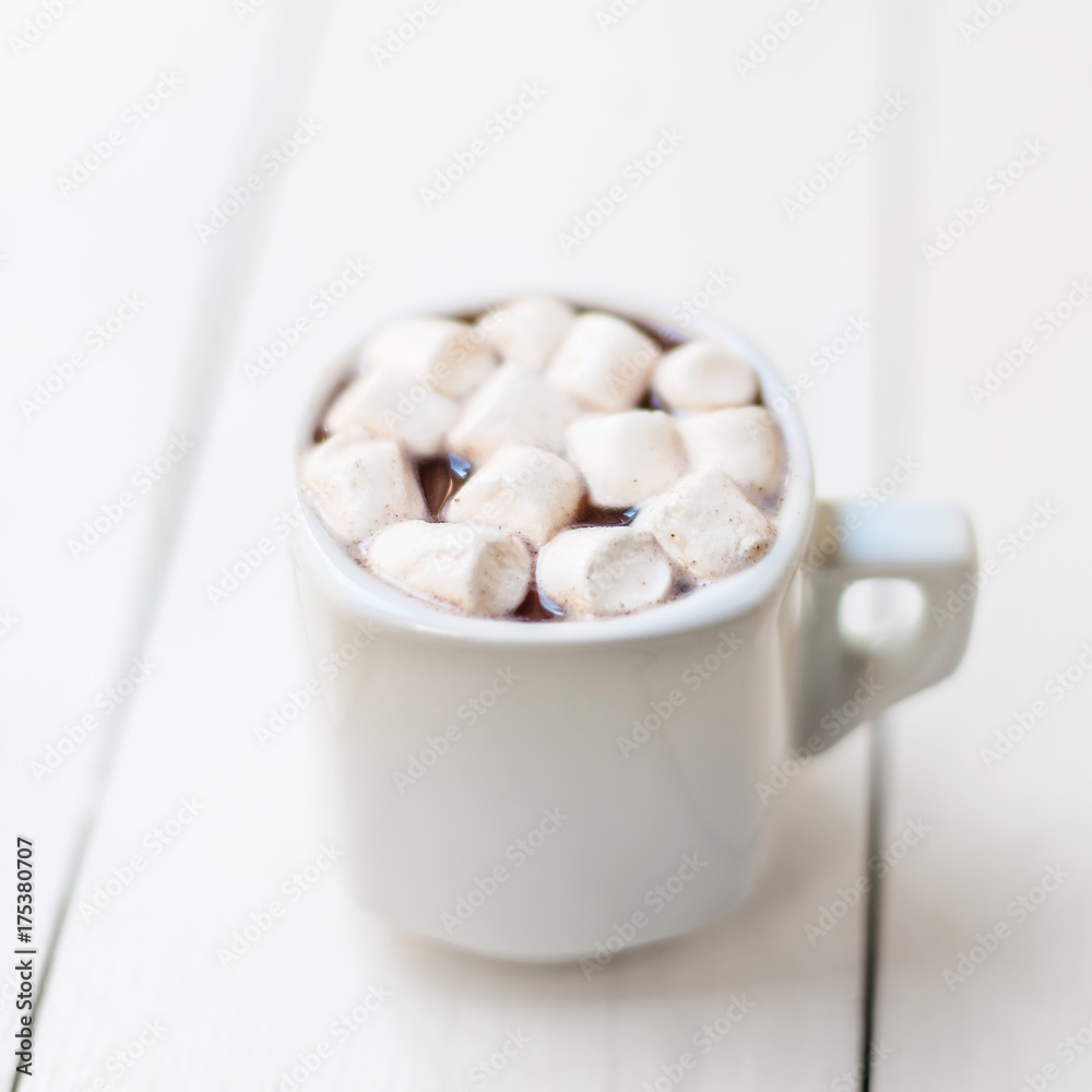 Hot cocoa with mini marshmallow on white rustic wooden table with copyspace. Winter Christmas cozy home concept Hot cocoa with mini marshmallow on white rustic wooden table with copyspace. Winter Christmas cozy home concept