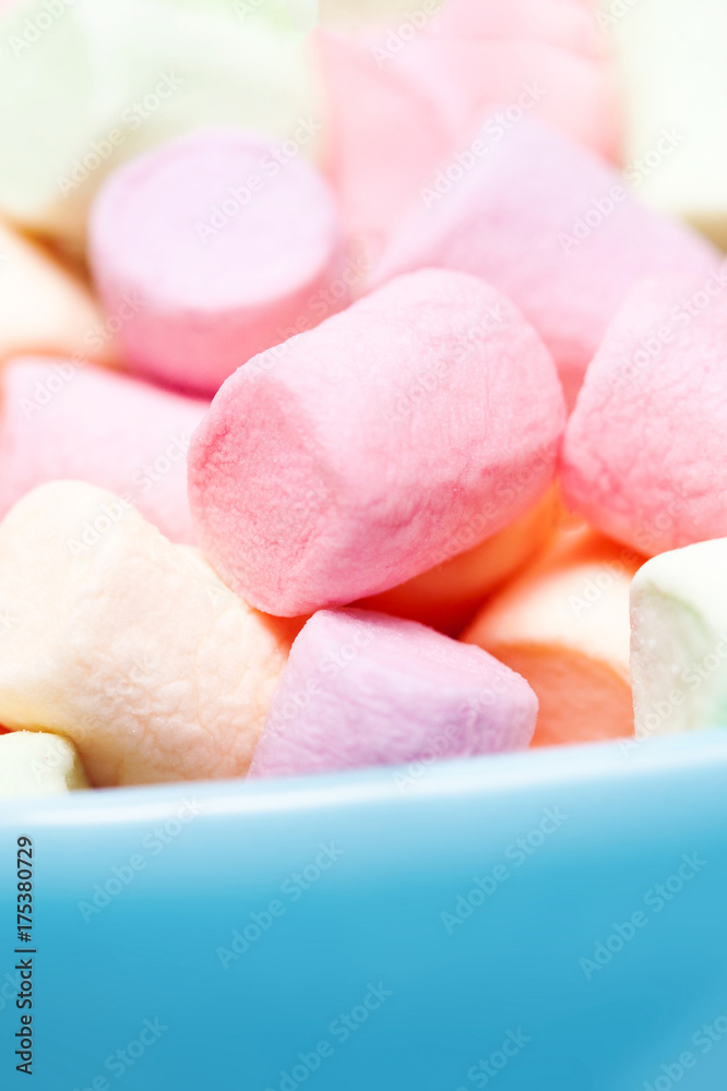 Colorful mini marshmallows in a blue bowl as background, macro. Fluffy marshmallows texture and pattern. High Resolution image, Soft focus Colorful mini marshmallows in a blue bowl as background, macro. Fluffy marshmallows texture and pattern. High Resolution image, Soft focus