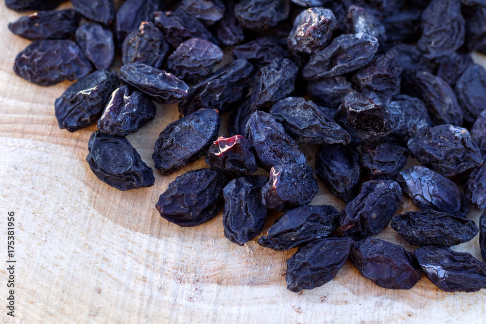 Prunes on wooden background, top view.