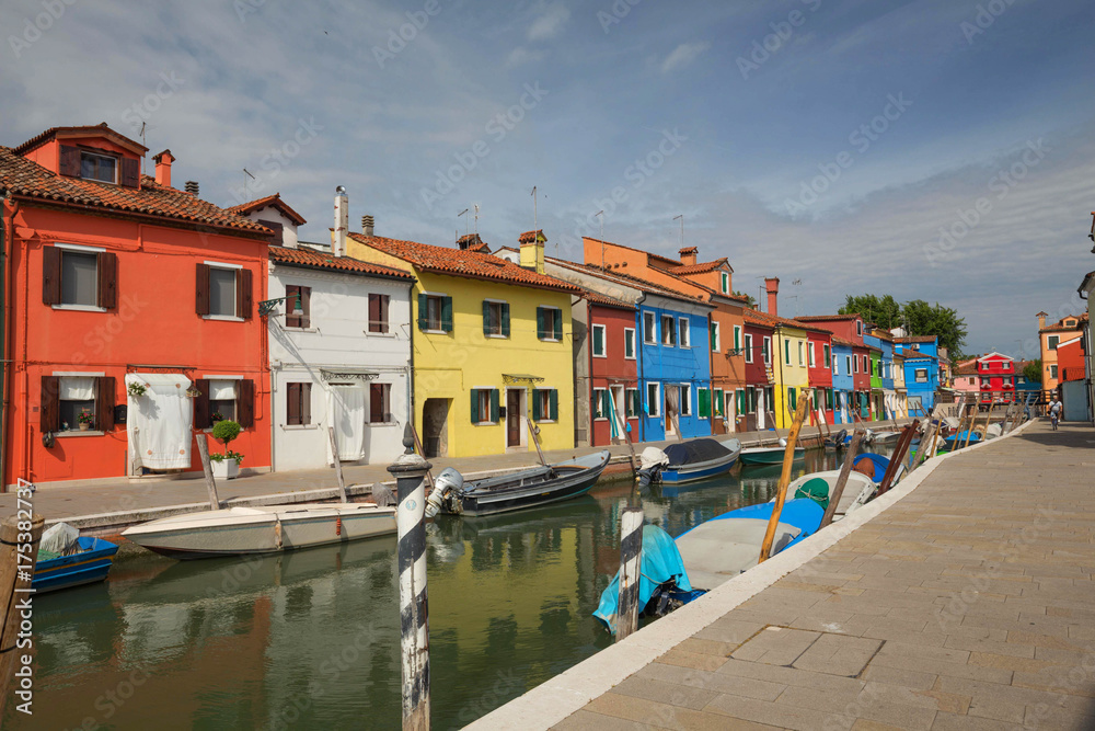 Colourful buildings lining cannal, Island of Burano, Venice Italy
