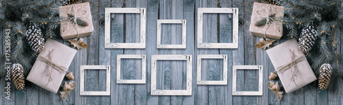 Christmas background with gift box and frames on wooden planks