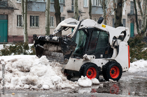 snow cleaning machine on the streets of the city in winter