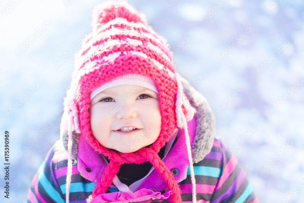 Little cute toddler girl outdoors on a sunny winter day. Little cute toddler girl outdoors on a sunny winter day.