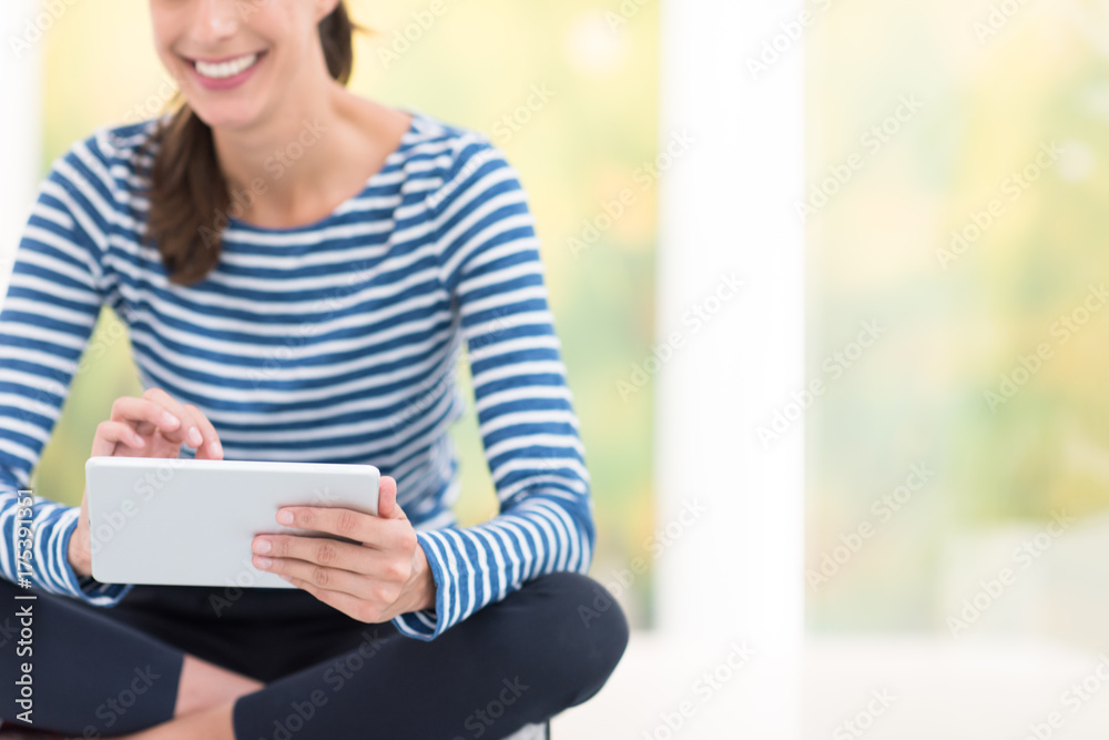 young women using tablet computer on the floor