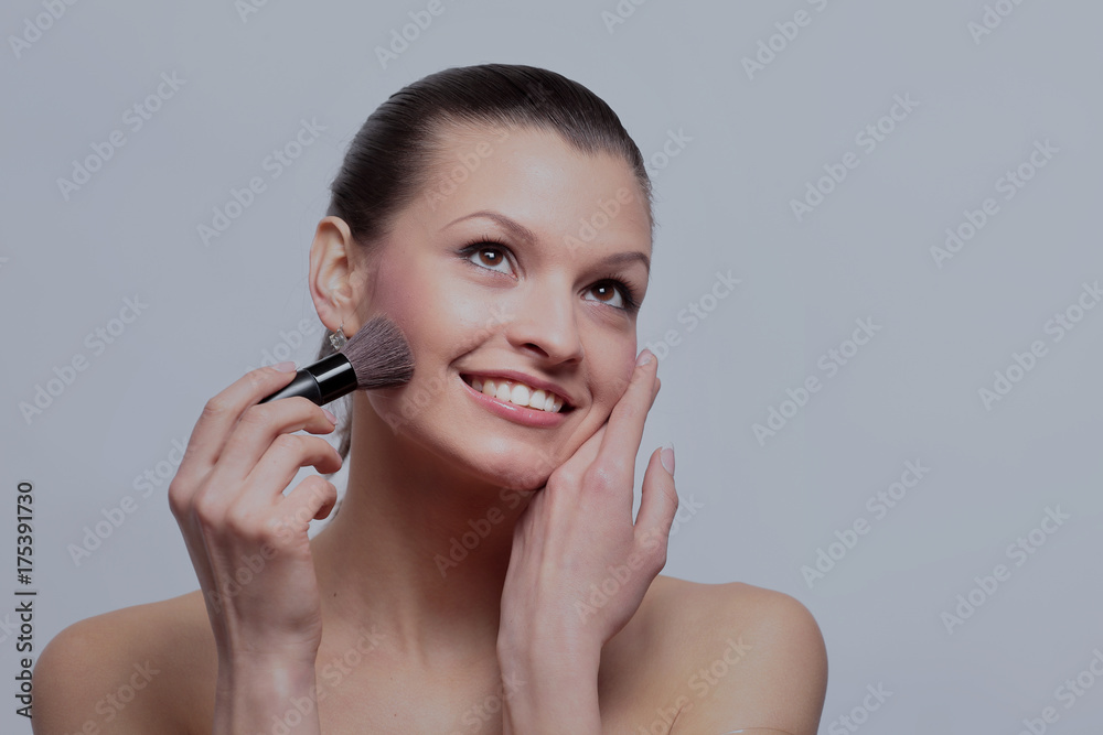 Smiling woman apply makeup