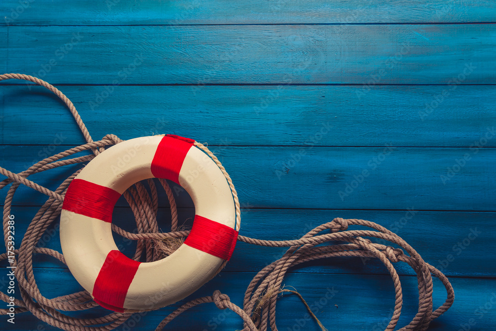 life saver with rope on a blue wooden background Stock-Foto | Adobe Stock