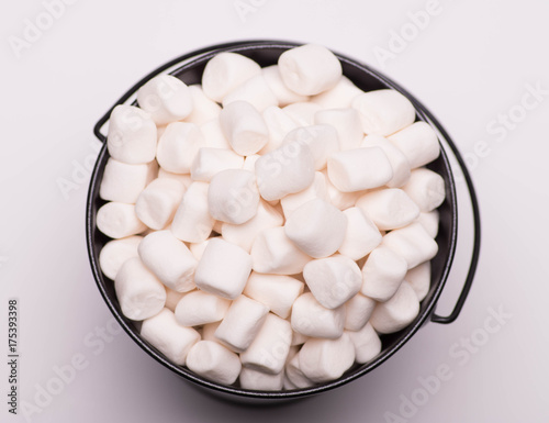 White mini marshmallows background close-up texture. Food background. Copy space. photo