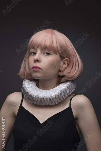 Girl in a medieval collar on a gray background