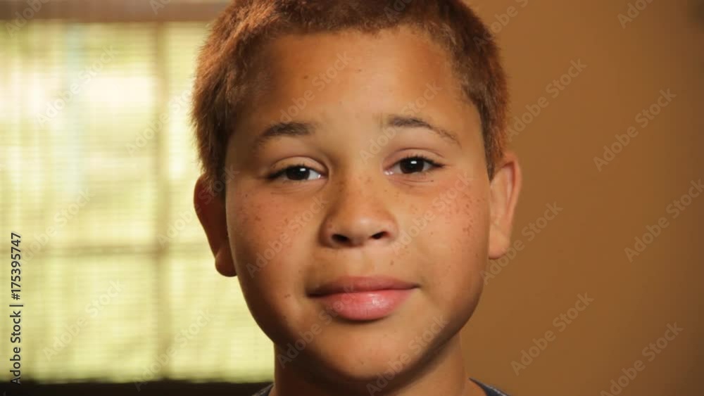 Close up, boy slowly smiles and laughs Close up, boy slowly smiles and laughs
