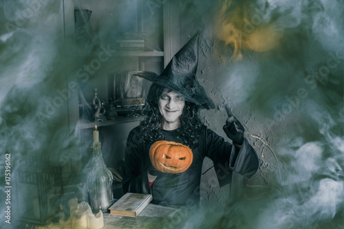 funny Halloween Witch with a magic Pumpkin