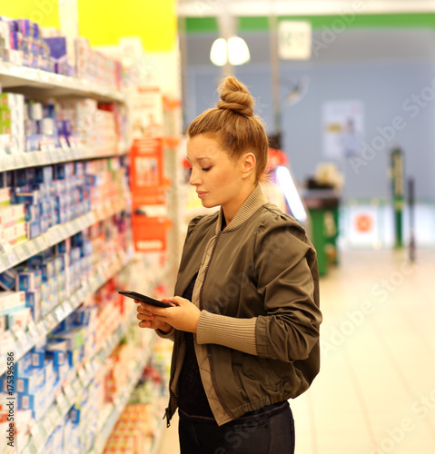Woman choosing a dairy products at supermarket 