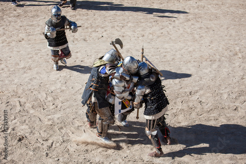 Men in a medieval battle. They are protected by armors from the 14th and 15th centuries Medieval Wrestling Combat