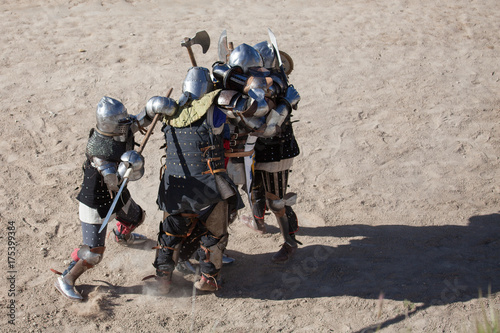 Men in a medieval battle. They are protected by armors from the 14th and 15th centuries Medieval Wrestling Combat