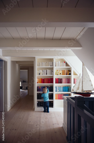 Boy in front of colorful bookcase photo