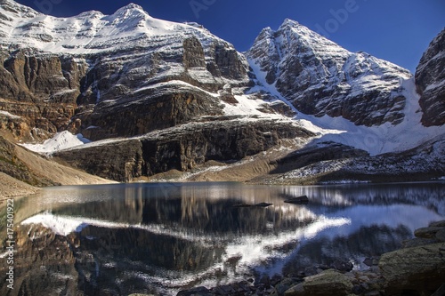 Snowy Rocky Mountain Tops Landscape reflected in calm water of Alpine Lake Oesa above Lake O'Hara in Yoho National Park British Columbia Canada photo