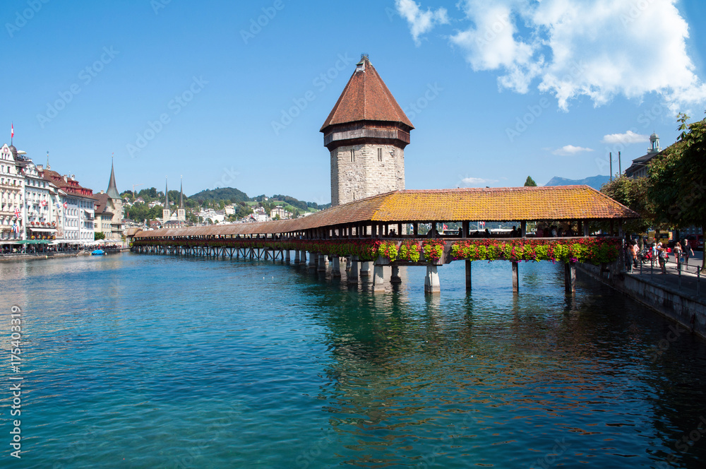 Lucerne, Switzerland - old wooden bridge over the river decorated with flowers