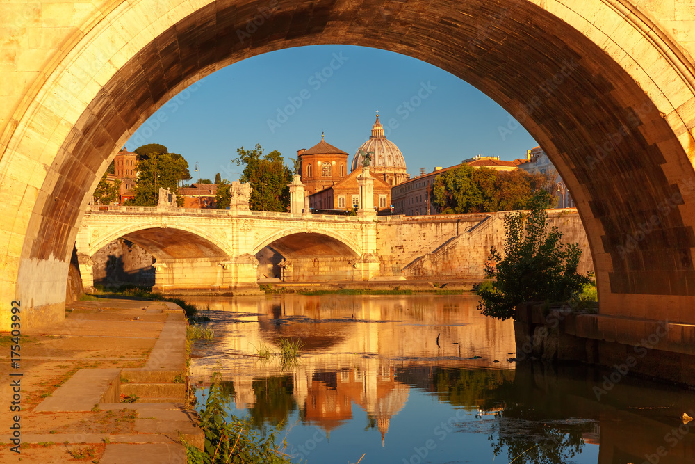 View of Tiber River, bridge Vittorio Emanuele II and Saint Peter Cathedral in the morning in Rome, Italy.