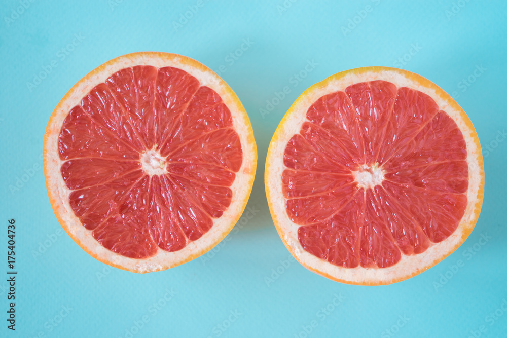 Halves of grapefruit on blue background Halves of grapefruit on blue background