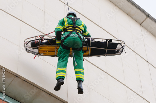 Paramedic is winched down a building on a rope with a patient during the launch of Northern Ireland Ambulance Service (NIAS) Hazardous Area Response Team (HART). photo