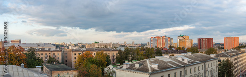 panoramic city view with old and modern buildings under the autumn cloudy sky