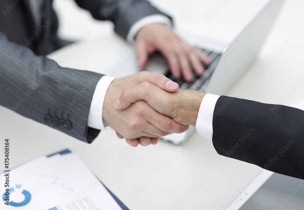 closeup .handshake of business partners above the Desk closeup .handshake of business partners above the Desk