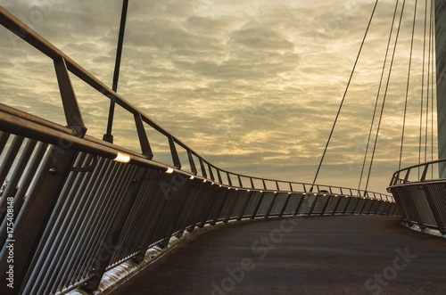 A cable-stayed bridge at sunset over the M20 Motoroway, Ashford, Kent, England photo