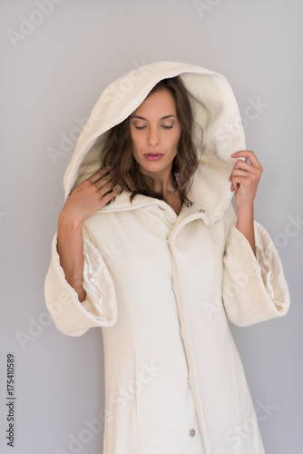 woman in a white coat with hood isolated on white background