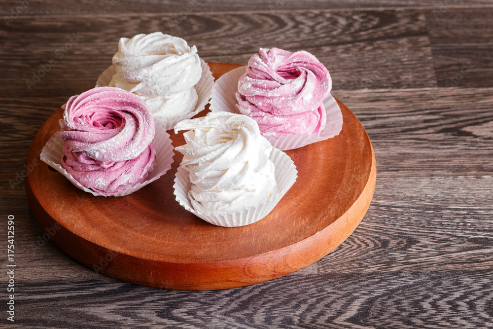 pink and white marshmallows on a round wooden board pink and white marshmallows on a round wooden board
