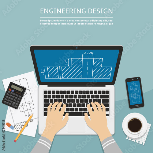 Engineer working on laptop computer with blueprint on screen