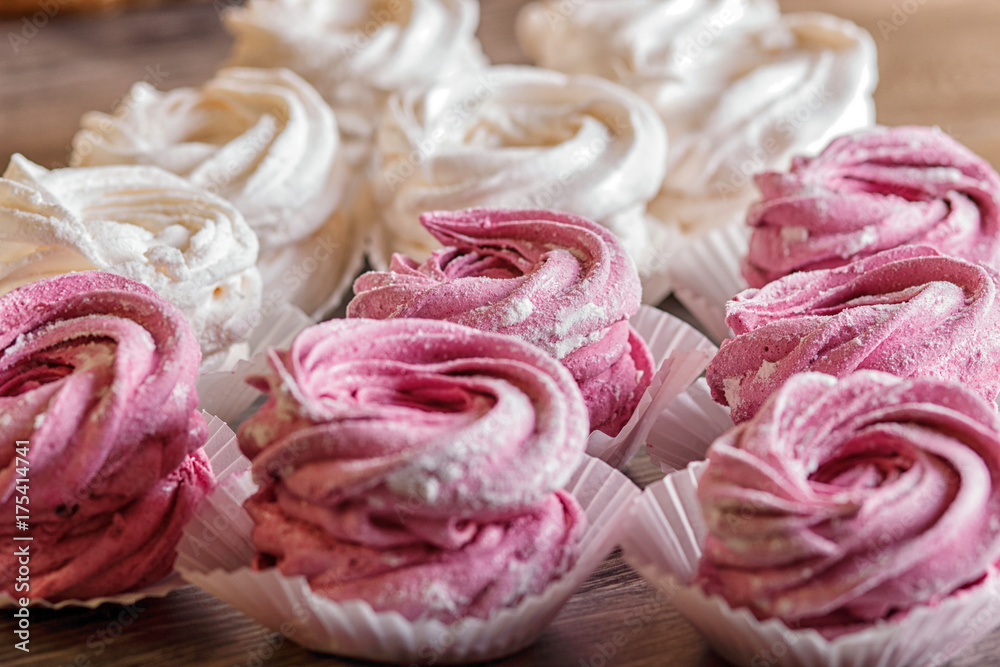 pink and white homemade marshmallows on a gray wooden background. pink and white homemade marshmallows on a gray wooden background.