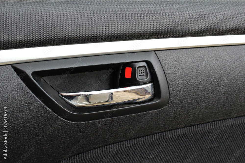 Close up of door control button on car.