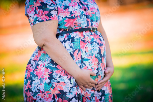Pregnant woman in colorful outdoor - Close up in belly