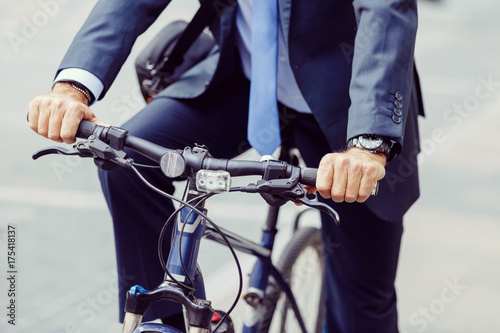 Successful businessman riding bicycle