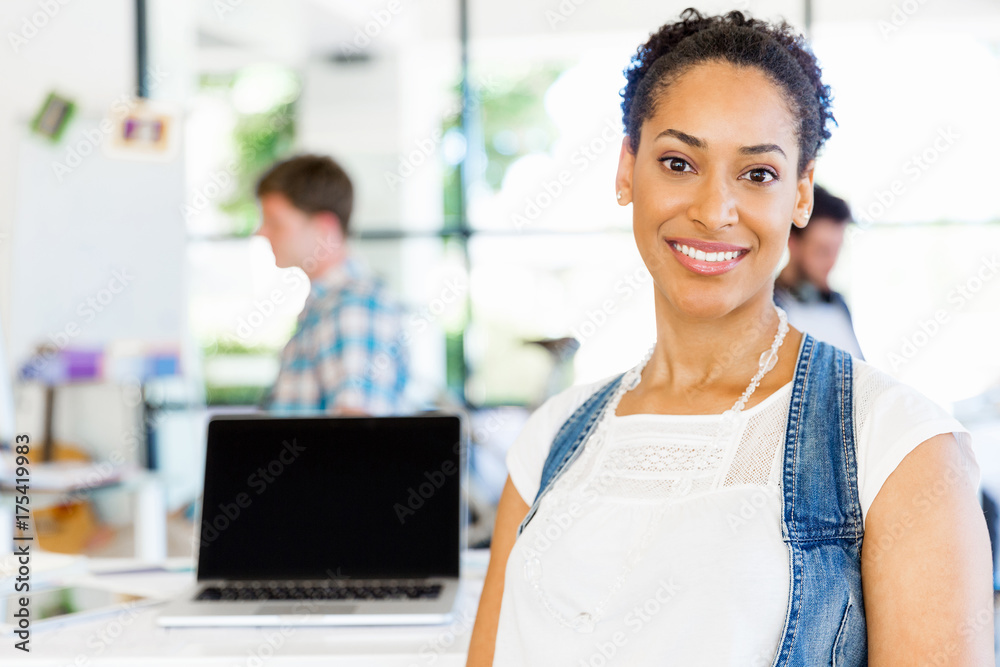 Portrait of smiling afro-american office worker sitting in offfice