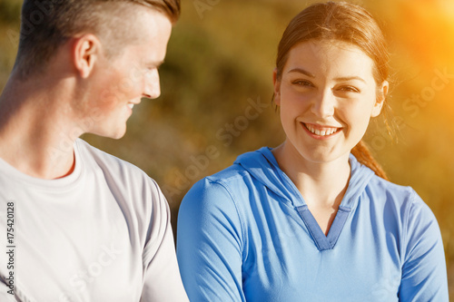 Young couple on beach in sportwear