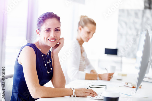 Attractive office worker sitting at desk