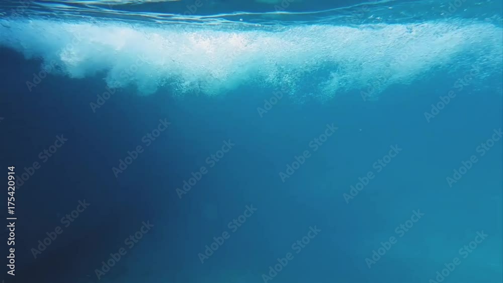 Bubbles in swimming pool underwater slow motion. Deep and blue water natural bubbles shot.