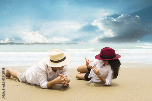Couple vacation taking photo on sand beach, Thailand