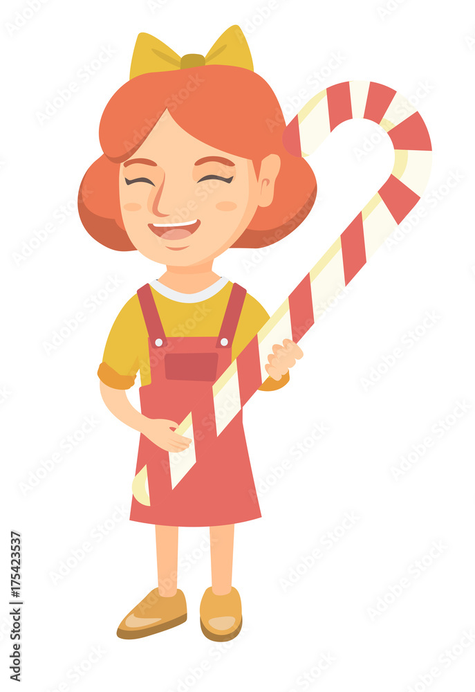 Happy caucasian little girl holding a christmas candy cane Happy caucasian little girl holding a christmas candy cane