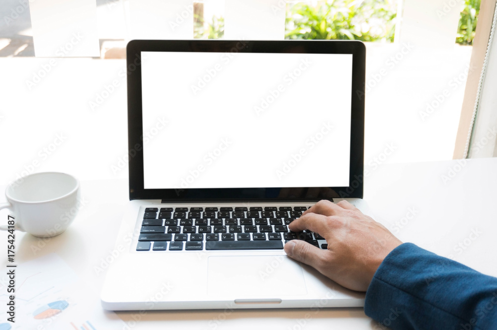 A man is working by using a laptop computer on wooden table. Hands typing on a keyboard A man is working by using a laptop computer on wooden table. Hands typing on a keyboard