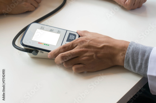 Doctor checking old woman patient arterial blood pressure. Health care.