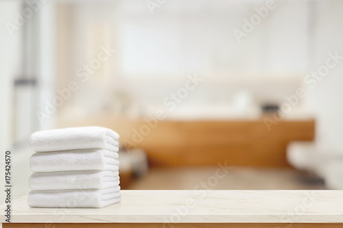 Towels on marble top table with copy space on blurred bathroom background.