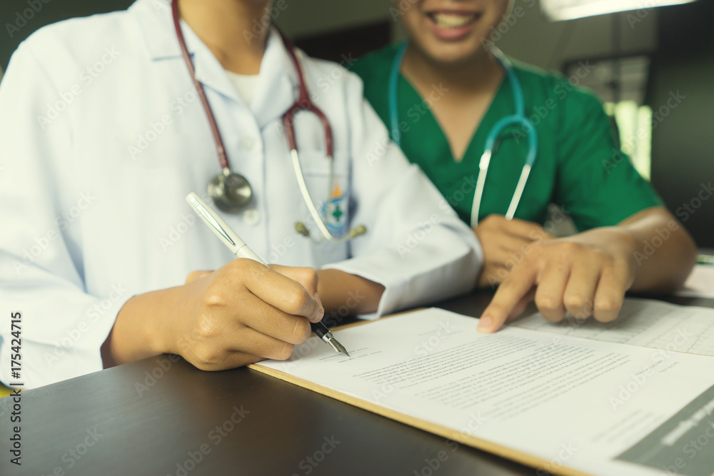 medicine, health care, meeting and people concept - doctor hand with clipboard writing medical prescription or certificate for insurance claim at hospital,Medicine doctor's working concept medicine, health care, meeting and people concept - doctor hand with clipboard writing medical prescription or certificate for insurance claim at hospital,Medicine doctor's working concept