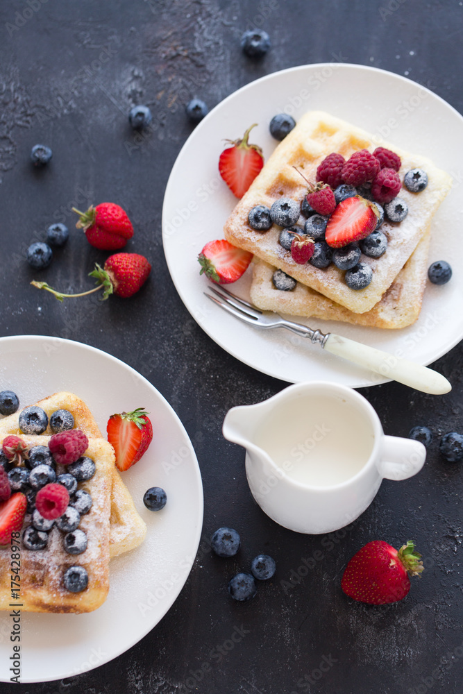 Belgian waffles with fresh berries on white plate. Belgian waffles with fresh berries on white plate.