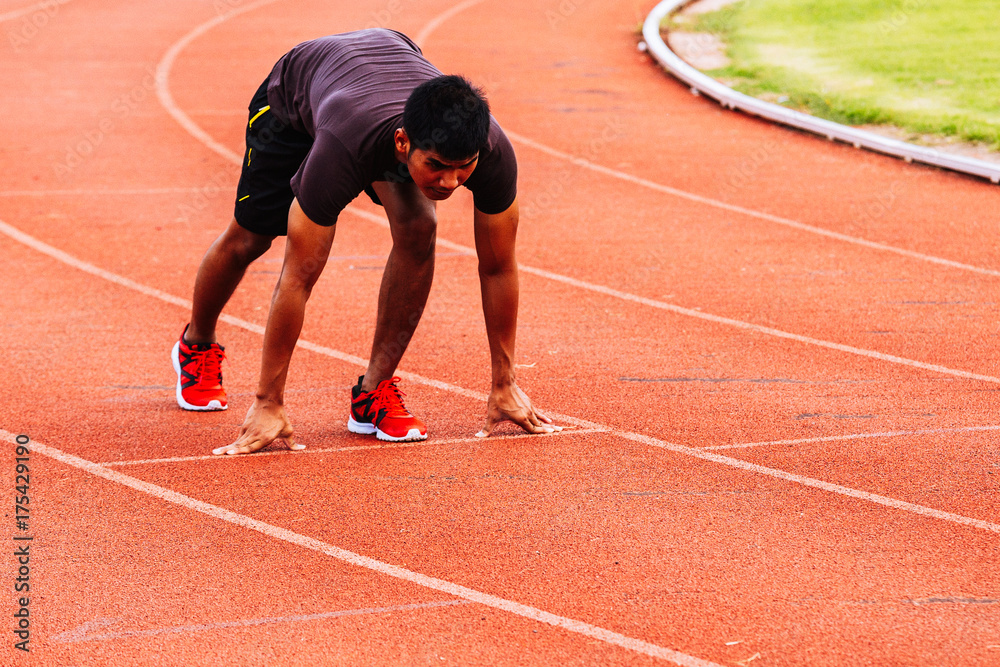 Healthy man running and jogging in morning ;Healthy people in run track of public stadium Healthy man running and jogging in morning ;Healthy people in run track of public stadium
