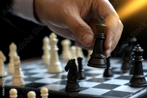 Billede på lærred Businessman play chess use King - Chess Piece white to crash overthrow