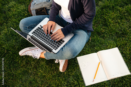 Top view of a female student studying on laptop computer