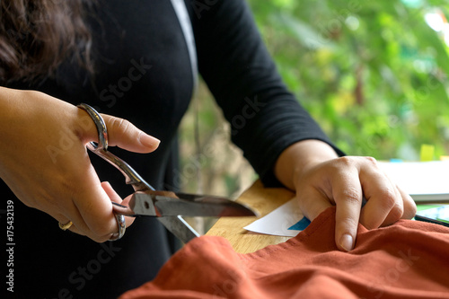 young fashion designer work with fabric cloth on the wood table