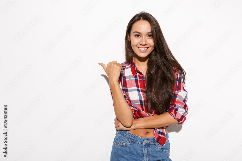 Young pretty long haired girl in checkered shirt showing thumb up gesture Young pretty long haired girl in checkered shirt showing thumb up gesture