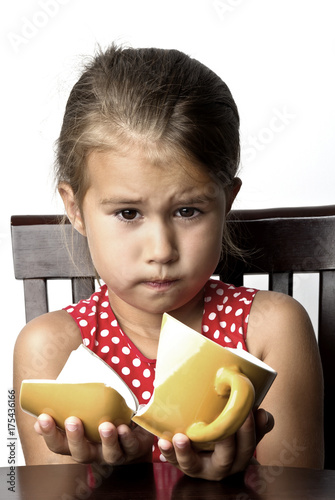 Frustrated little girl with a broken cup